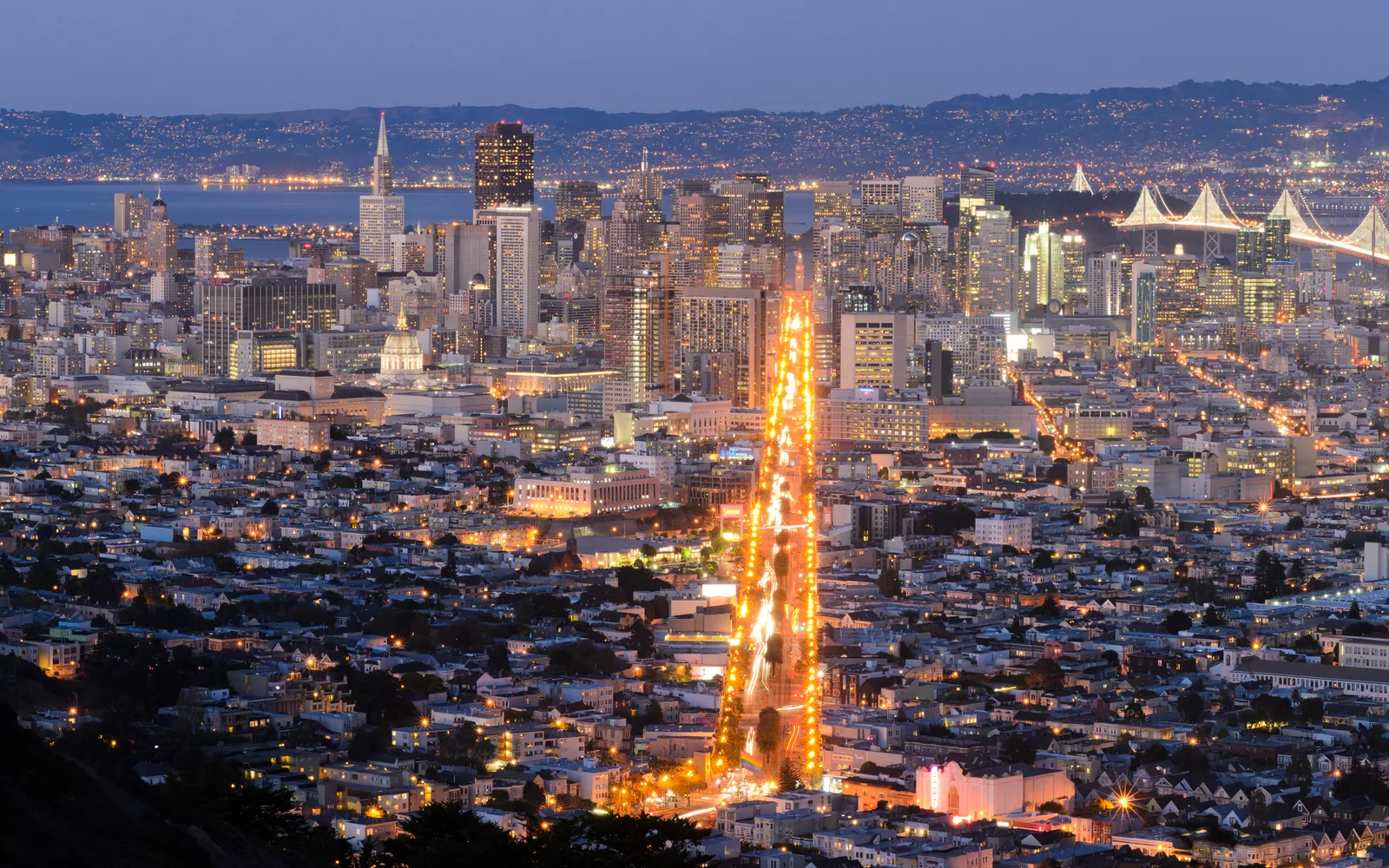 Panoramic view of the San Francisco skyline and downtown district from Twin Peaks viewpoint, showing the city's density and prominence in the Bay Area